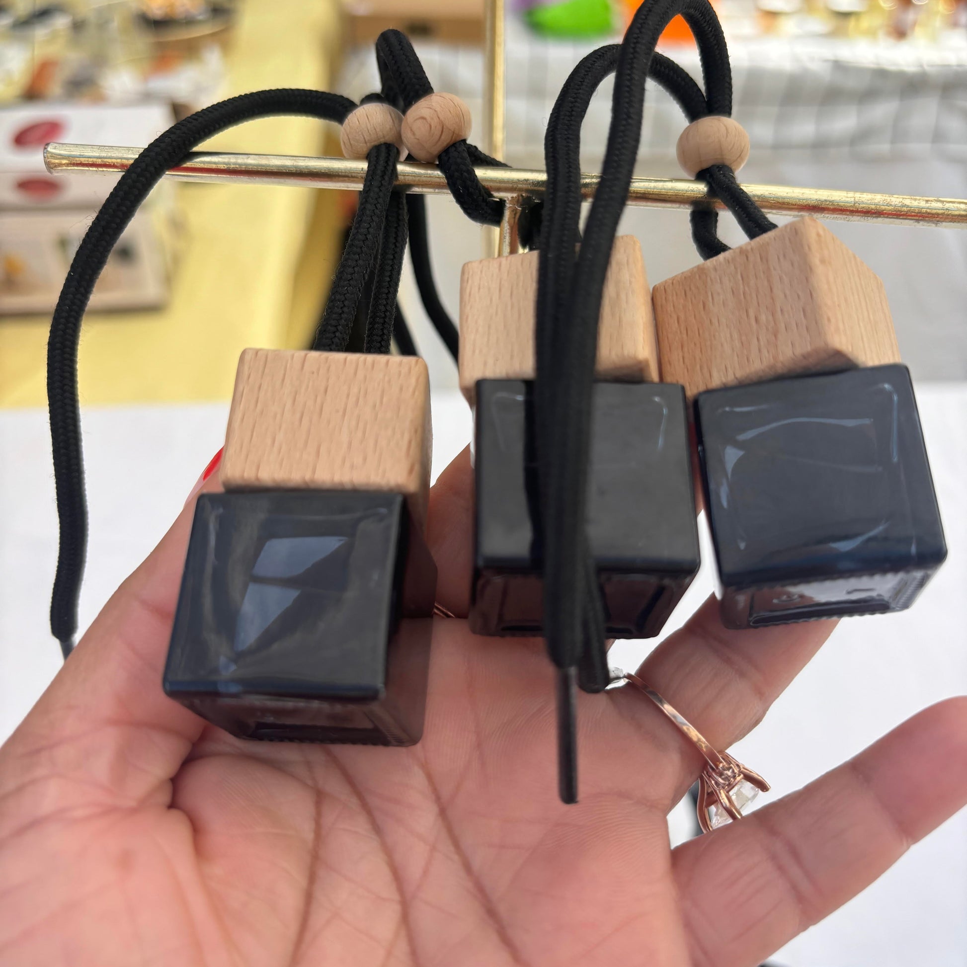 car diffuser in small black glass jar and wood lid freshens up your car or closet